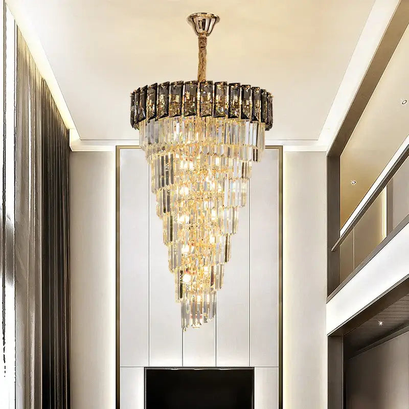 French luxury amber crystal chandelier with tiered cascading clear and dark rectangular crystals and gold frame for living room