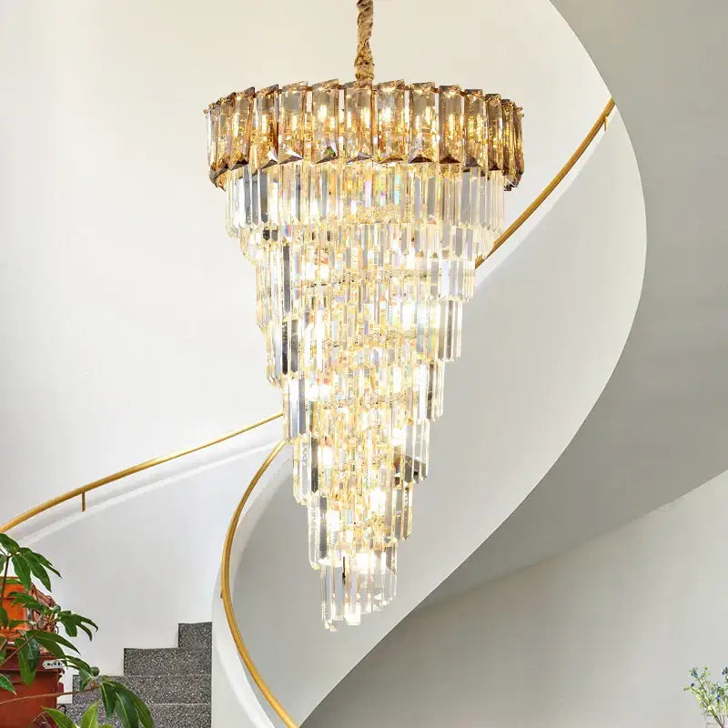 French luxury amber crystal chandelier with tiered clear and gold-toned glass prisms hanging from braided rope