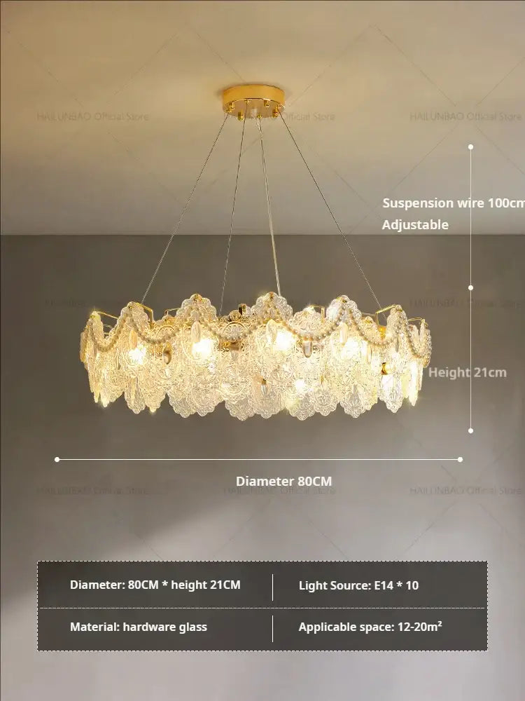 Elegant gold-toned decorbites glass chandelier with intricate layered crystal petals and central hardware frame for dining room
