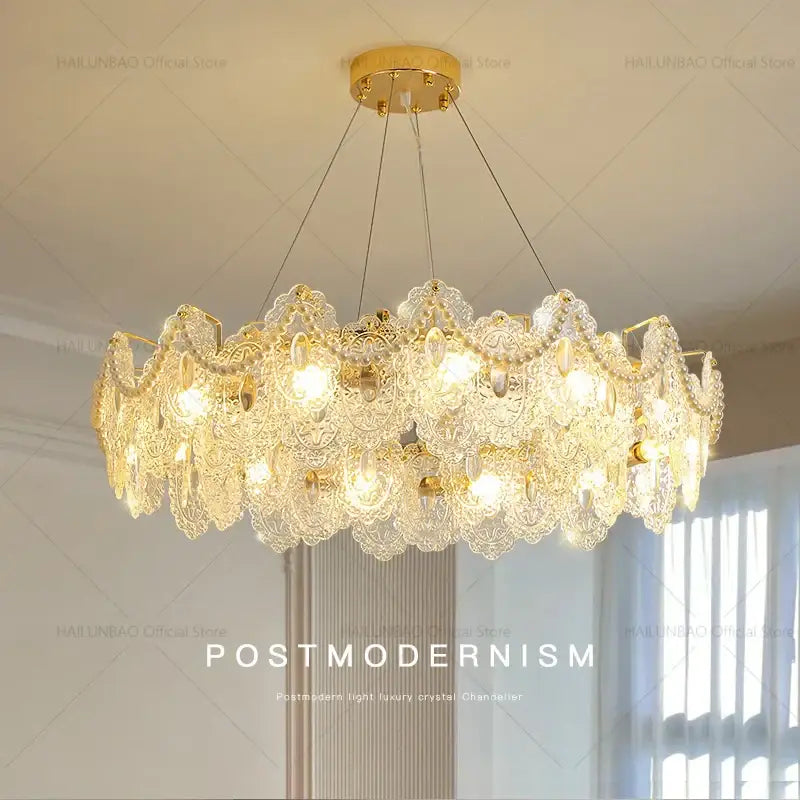 Gold-toned decorbites glass chandelier with intricate crystal lace detailing and dangling teardrop crystals for dining room use