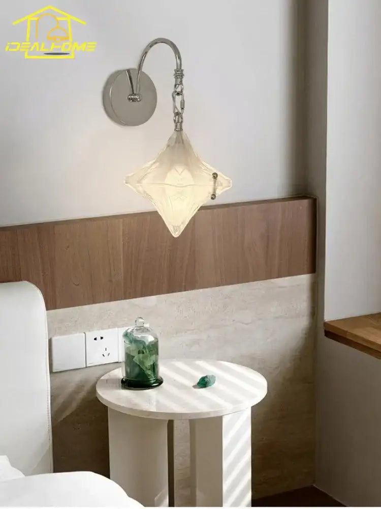 Delicate french medieval bauhaus wall lamp with diamond-shaped off-white glass shade and ornate chrome metal arm for living room