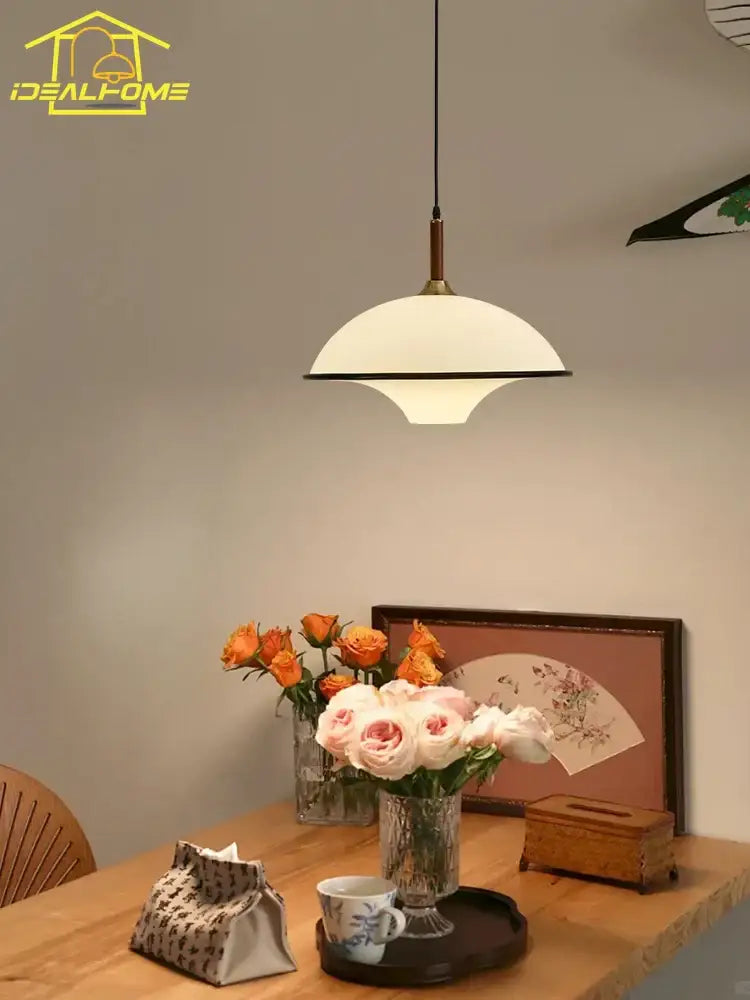 Cream-colored dome pendant light with black rim and brass accents for dining room decorbites french medieval saucer