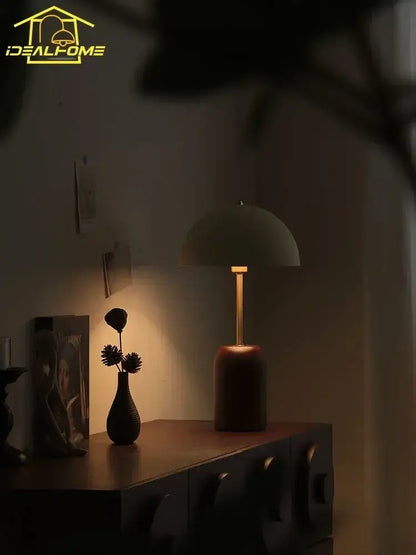 A sleek french medieval solid wood cream table lamp with matte olive green dome shade and brass base for decorbites