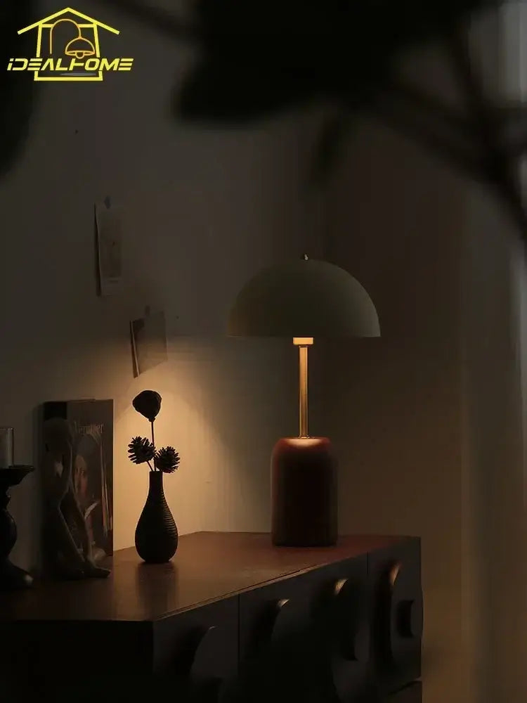 A sleek french medieval solid wood cream table lamp with matte olive green dome shade and brass base for decorbites