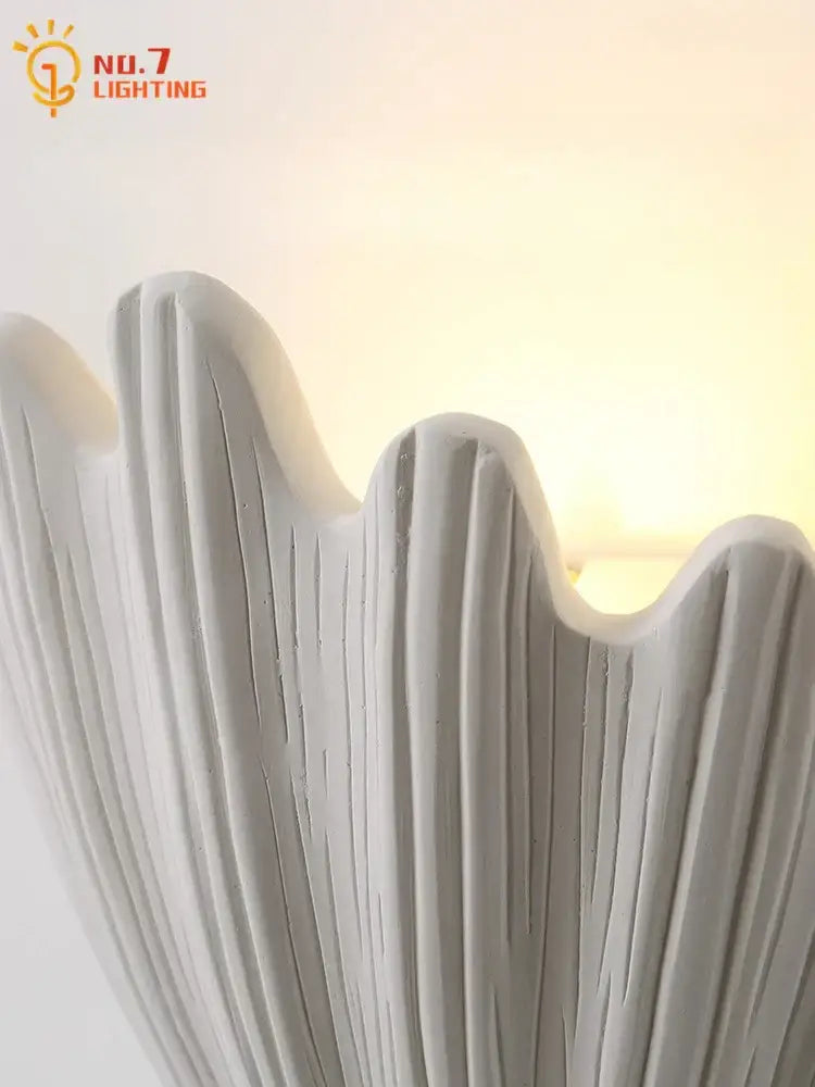 White textured ceramic wall lamp with scalloped edge and vertical ridges french medieval decorbites design