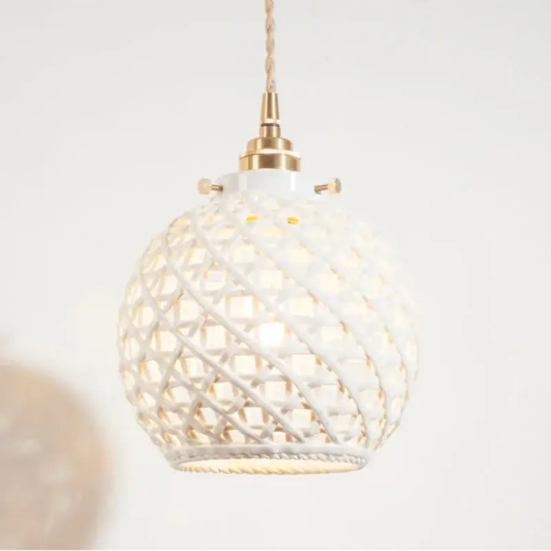 White woven ceramic pendant light with gold toned metal fixture and twisted cord for decorbites french minimalism dining room