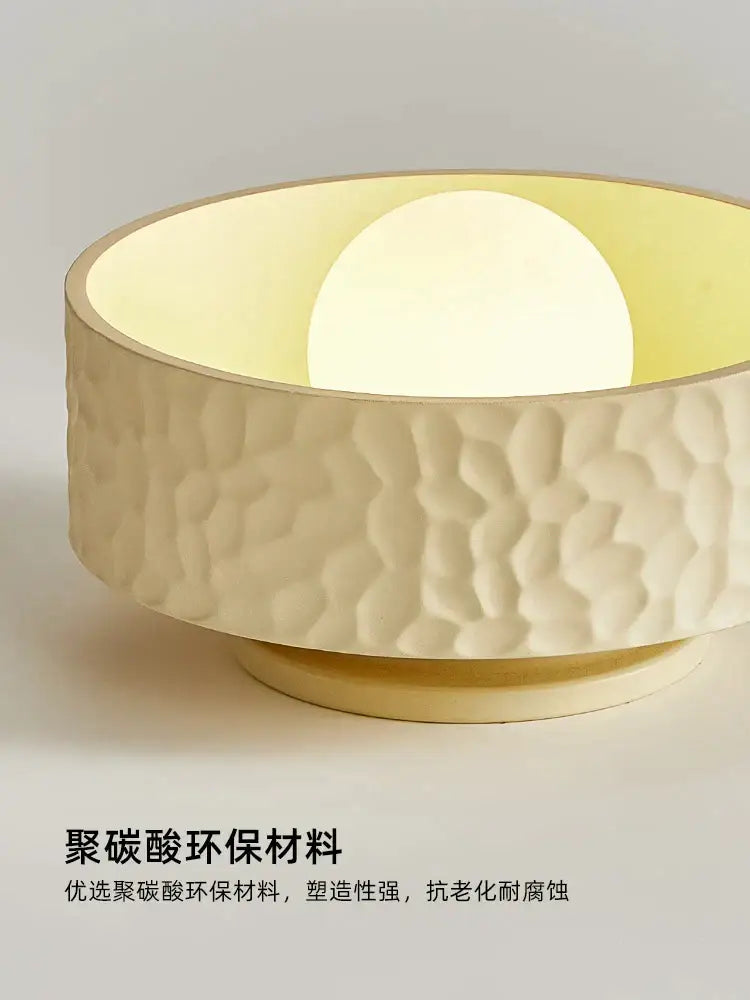 Cream-colored textured ceiling light made of eco-friendly polycarbonate with warm diffused glow for decorbites french minimalist