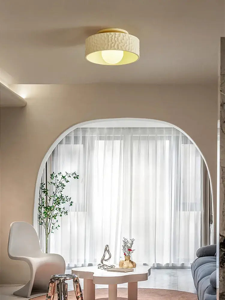 Cream-colored textured ceiling light with warm diffused glow for living room decorbites french minimalist cream style