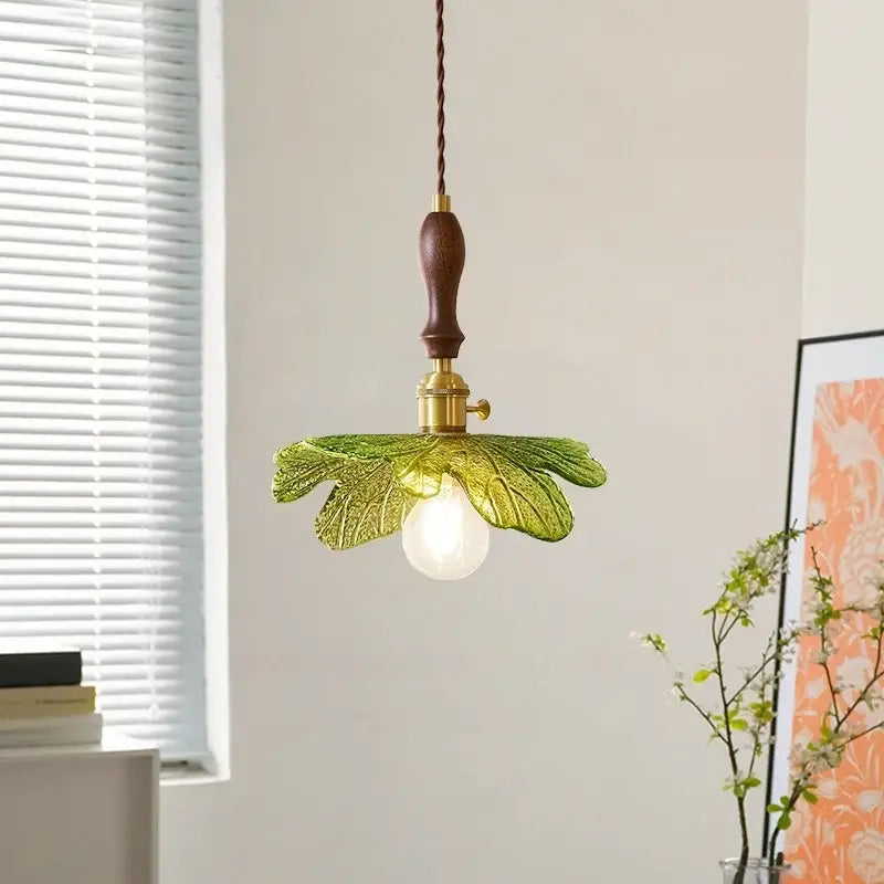 Delicate green glass pendant lamp with copper wood handle and brass accents for french minimalist dining room decorbites copper wood