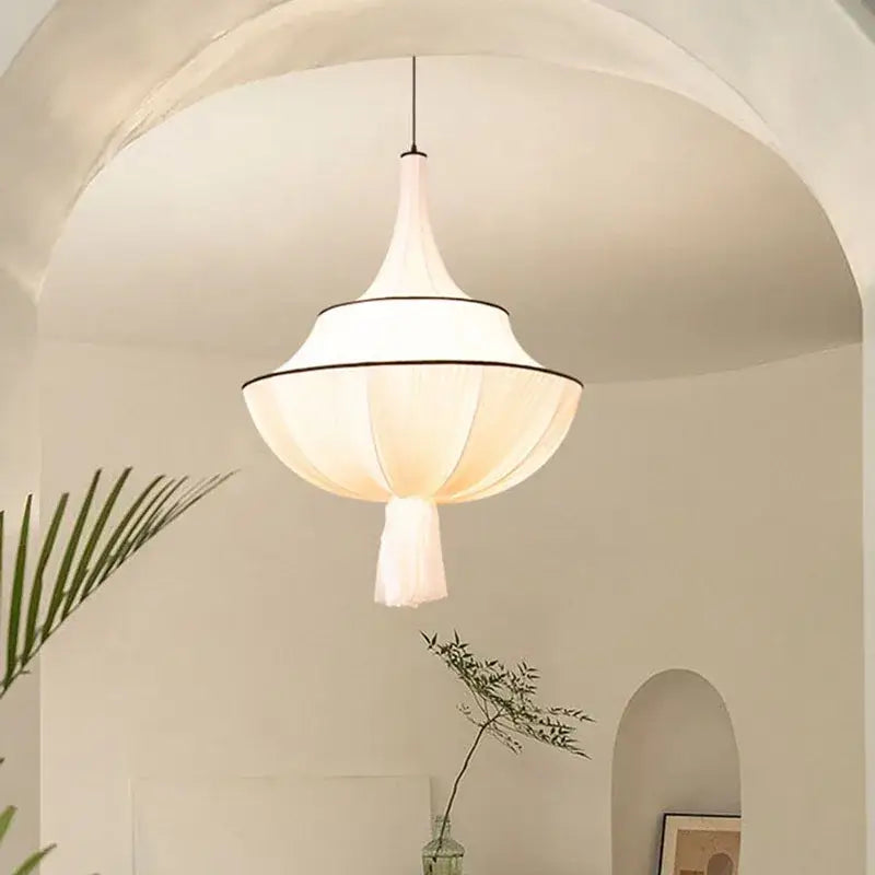 A soft white tiered pendant lamp with delicate black trim and silk shade for decorbites french minimalist living room decor