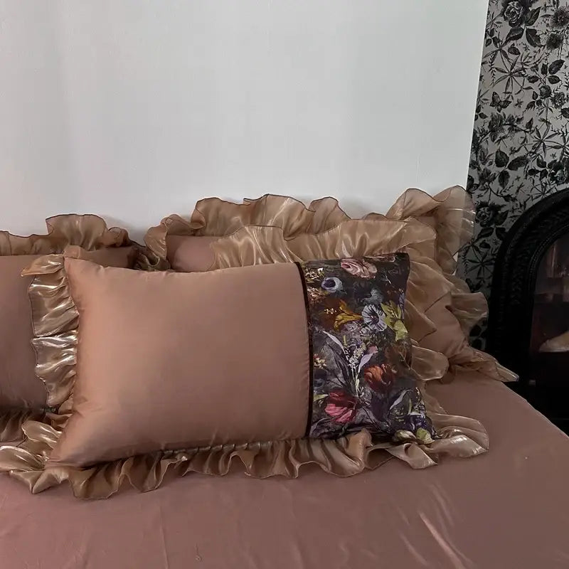 A plush taupe satin pillow with gold ruffled trim and floral print from decorbites french organza lace bedding set