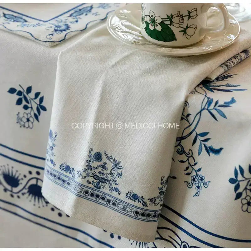 Cream-colored linen onion print tablecloth with intricate blue floral decorbites blue onion pattern for dining room decor