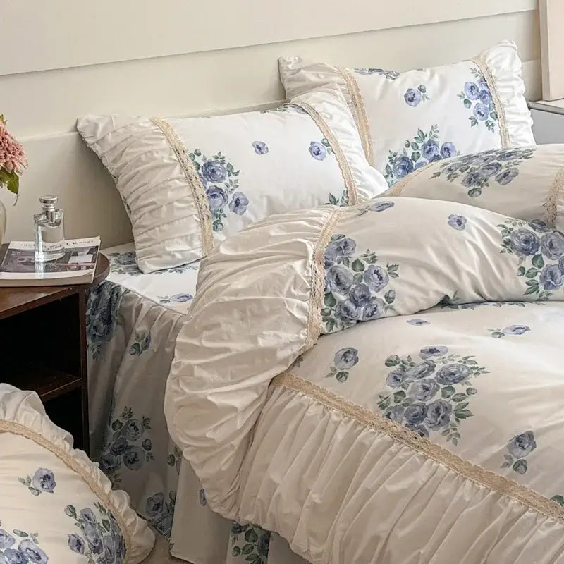 Cream-colored satin bedding set with blue floral prints and lace trim from decorbites french pastoral princess collection