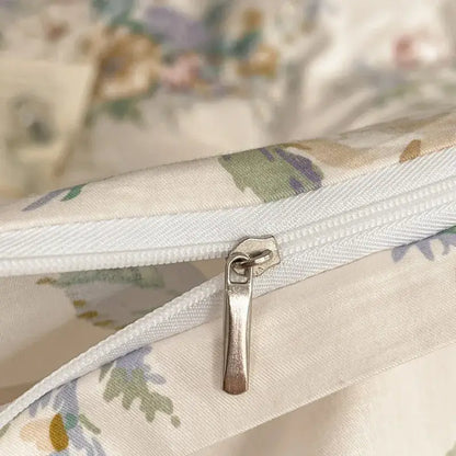 A silver-toned zipper pull on white pastel floral fabric of the decorbites french pastoral princess bedding set