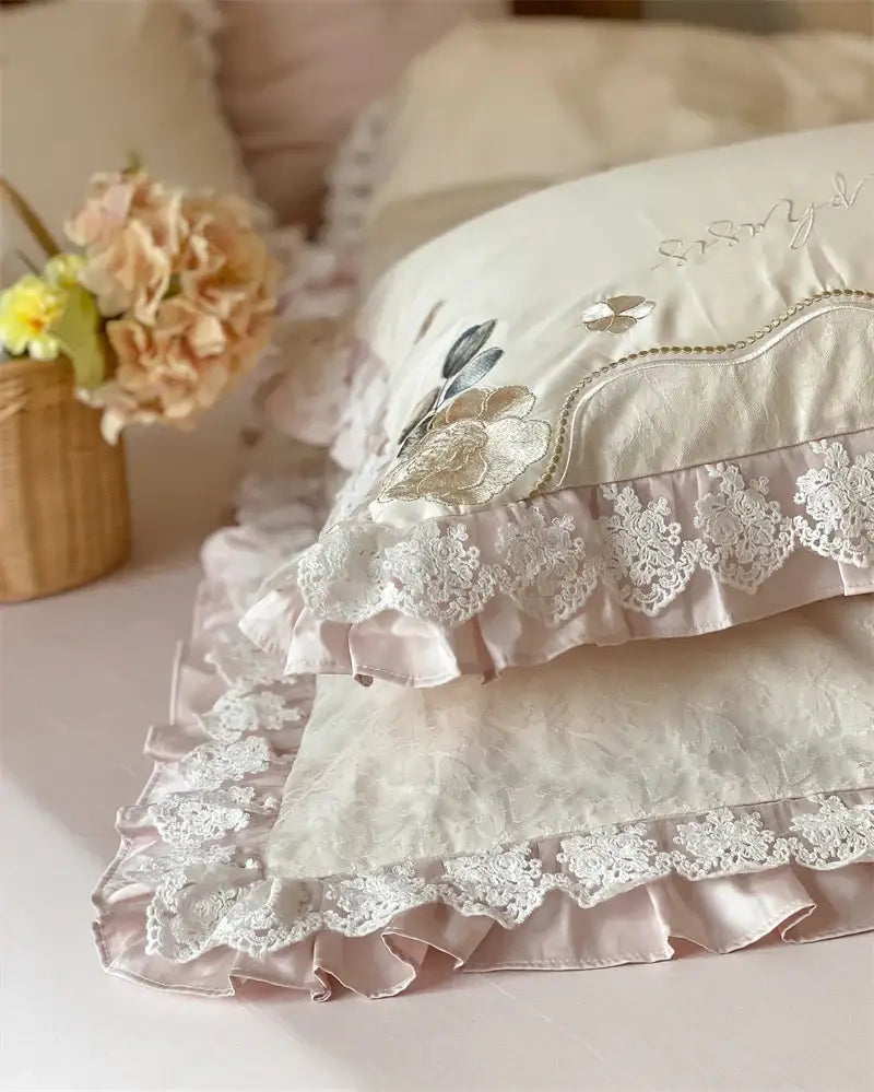 Cream-colored pillowcases with lace trim and embroidered florals from decorbites french princess 1000tc bedding set