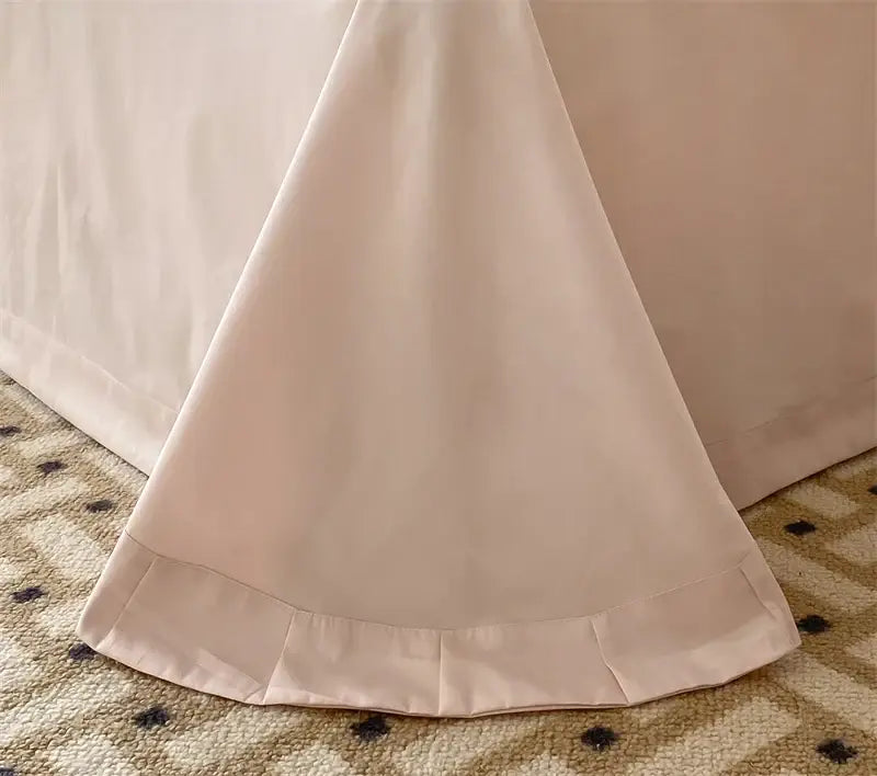 A soft blush-colored bed skirt with delicate pleated hemline from decorbites french princess 1000tc bedding set