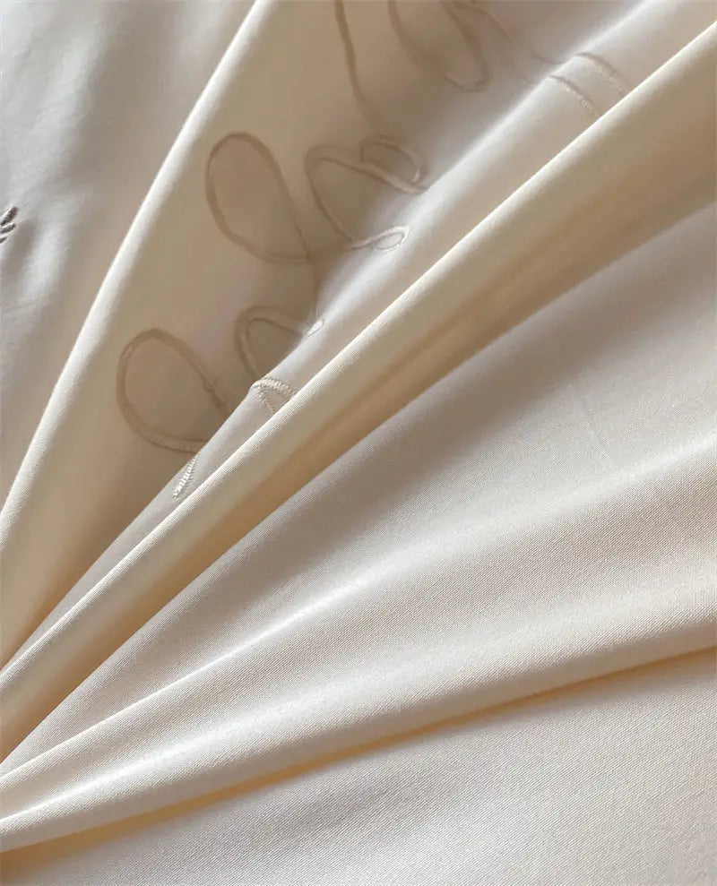 Cream-colored satin fabric with beige embroidered script patterns in decorbites french princess 1000tc bedding set
