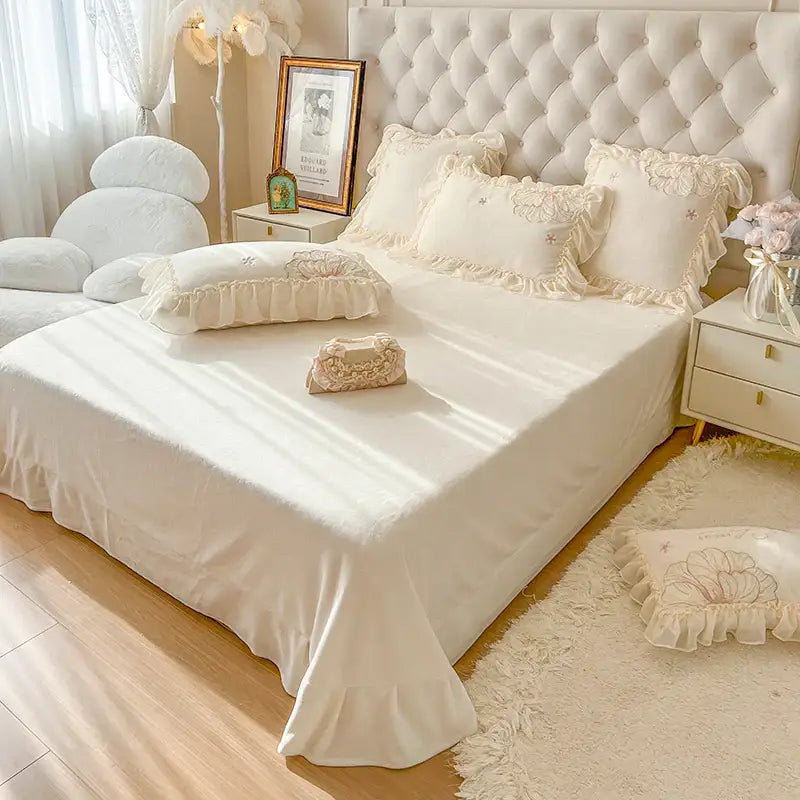 Cream-colored satin bedding set with delicate ruffled edges and floral embroidery by decorbites french princess