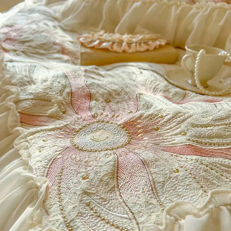 A cream quilted bedding set with pink and gold floral embroidery and ruffled edges by decorbites french princess
