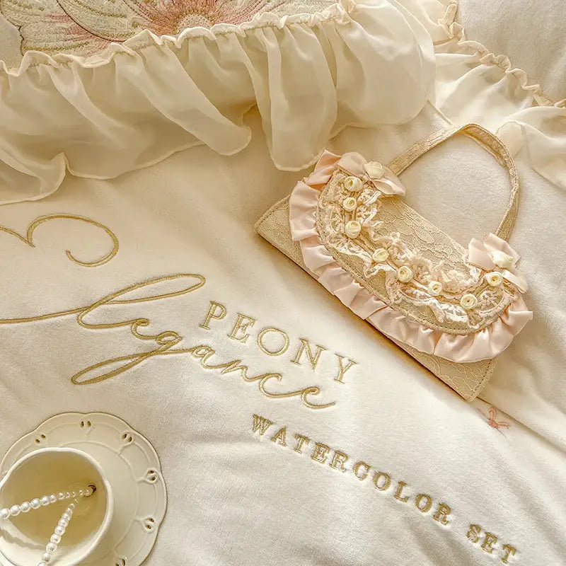 A delicate blush pink clutch with lace pearls and satin ruffles complementing decorbites french princess bedding set