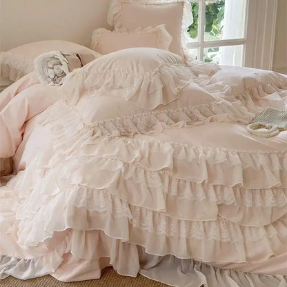A soft blush pink decorbites french princess bedding set with ruffles and layered lace trim for elegant bedroom decor