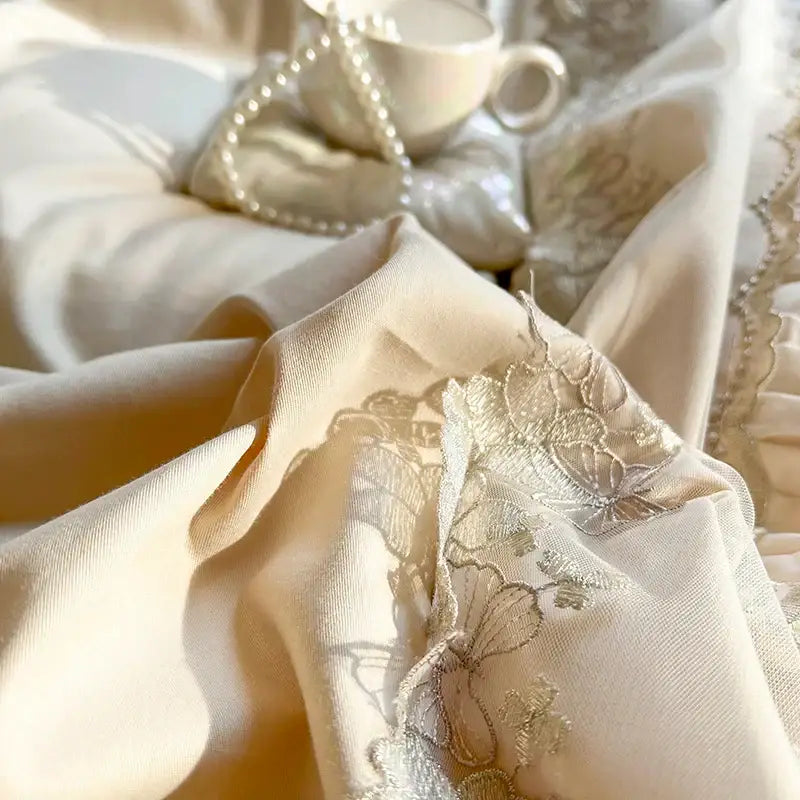 Cream-colored satin bedding set with delicate silver thread floral and butterfly embroidery from decorbites french princess