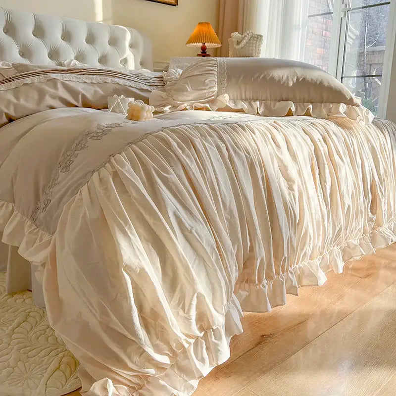 Cream-colored ruffled bedding set with lace trim and gathered fabric from decorbites french princess cotton collection