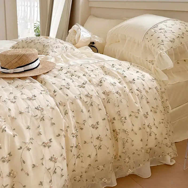 Cream-colored bedding set with delicate silver floral embroidery and ruffled lace trim french princess floral decorbites