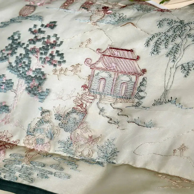 A cream silk pillowcase with hand-embroidered Chinese scenes in the french princess ivory and green lace ruffles bedding set