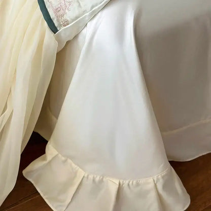 Cream-colored satin bed skirt with lace ruffles and delicate embroidery for french princess bedding set