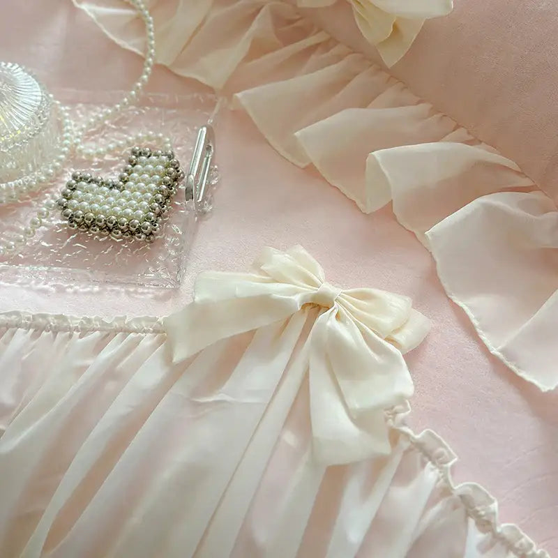 A delicate ivory satin bow with soft folds on decorbites french princess lace pink velvet bedding set for elegant bedroom decor