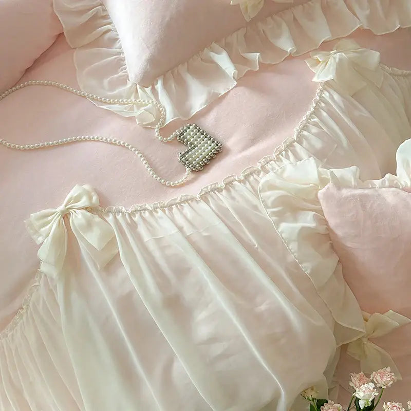 Cream-colored satin ruffled nightgown with delicate bow ties at the waist complementing decorbites french princess lace bedding set