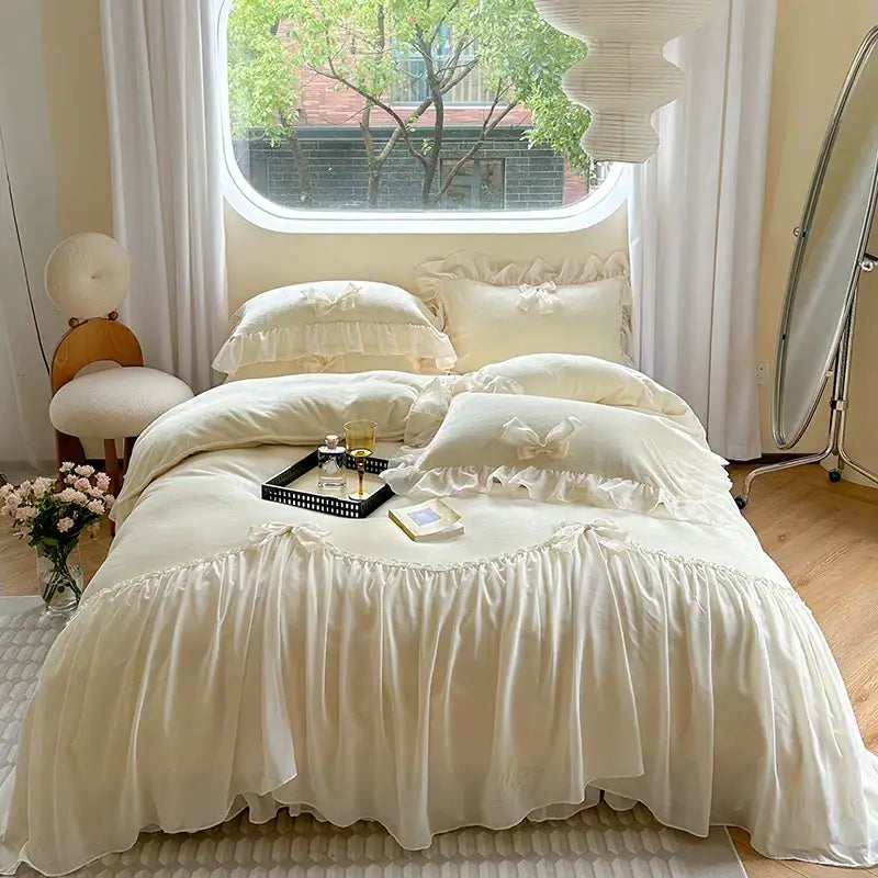 Cream-colored ruffled bedding set with lace trim and embroidered bows in decorbites french princess lace style