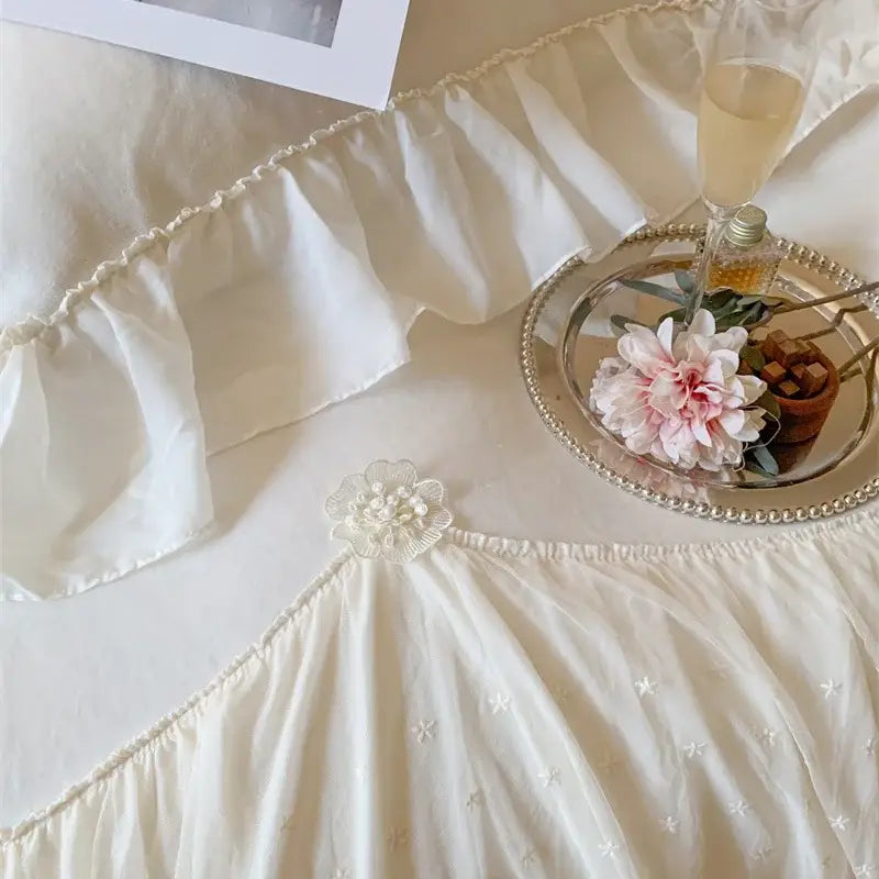 Off-white velvet ruffled skirt with delicate star embroidery and floral waist embellishment in decorbites french princess bedding set