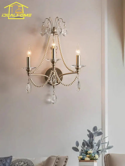 Antique brass three-light wall lamp with dangling crystal droplets and pearl beads decorbites french retro living room sconce
