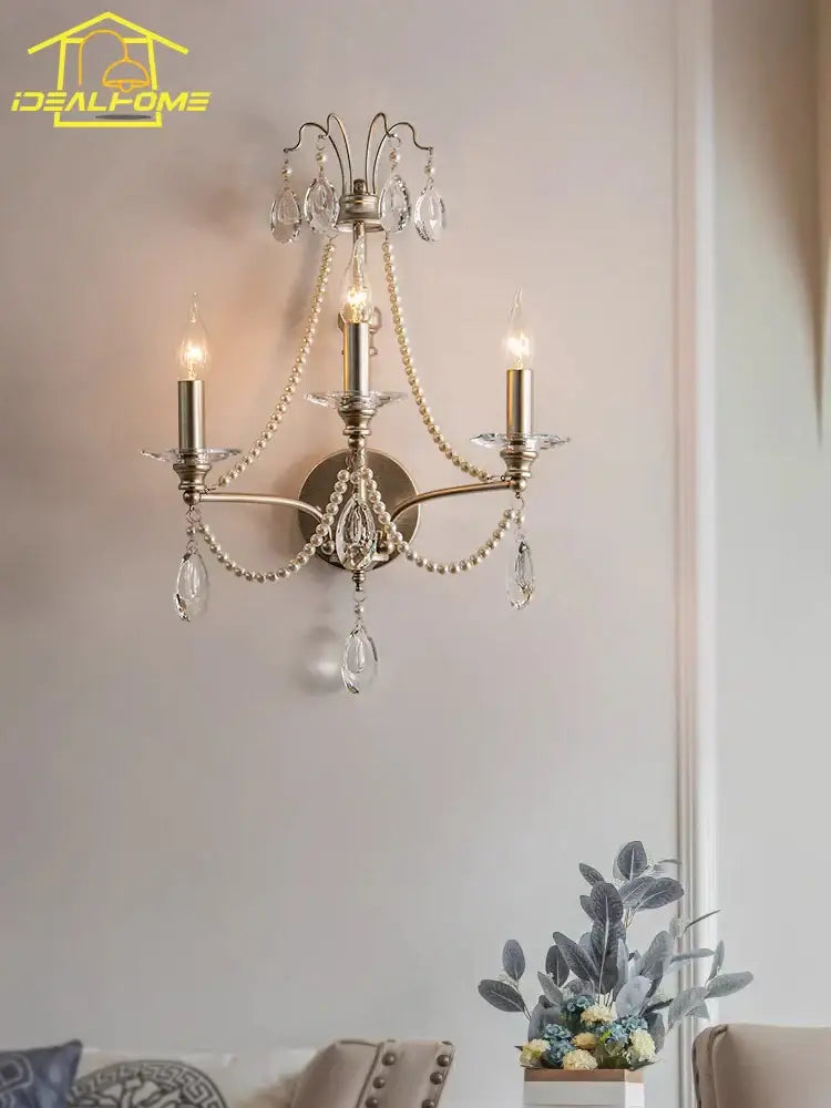 Antique brass three-light wall lamp with dangling crystal droplets and pearl beads decorbites french retro living room sconce