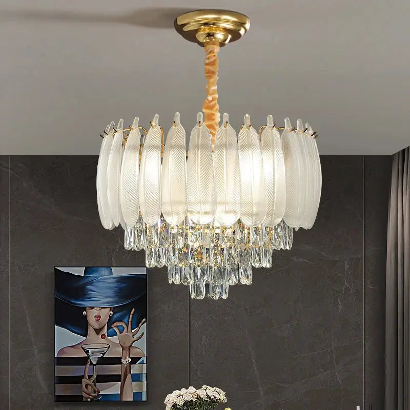 Elegant gold-toned decorbites crystal feather chandelier with translucent white glass shades and dangling crystal droplets for dining rooms