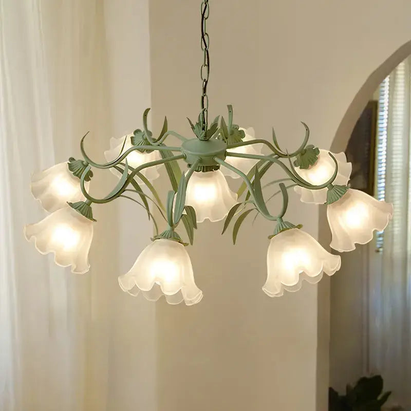 A delicate mint-green french retro led flower chandelier with eight frosted glass bell shades and leafy metal arms