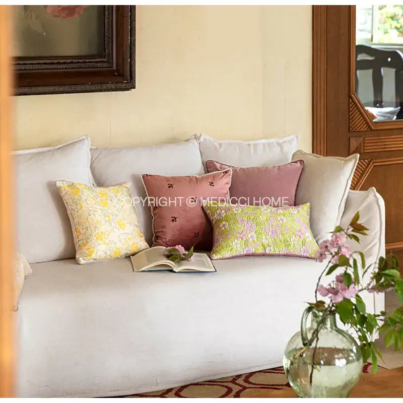 White upholstered sofa with decorbites contessa camellia throw pillow in light green floral pattern for living room decor