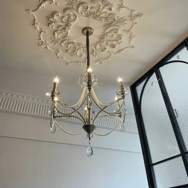 An elegant french retro pearl crystal chandelier in antique brass with crystal droplets and beaded chains for dining room decor