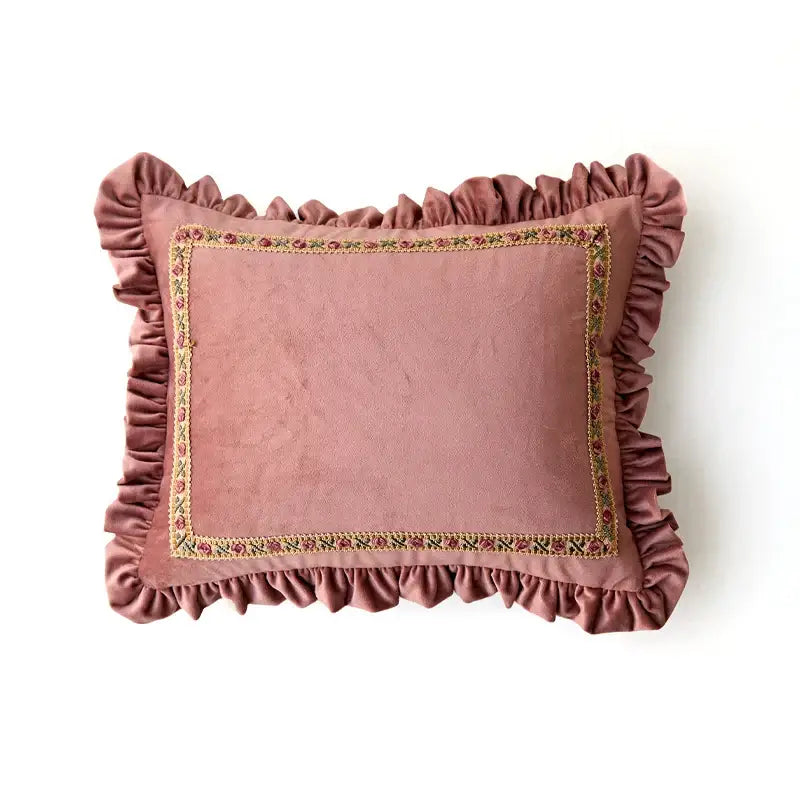 A soft dusty rose velvet decorative cushion cover with ruffled edge and embroidered floral border for living room