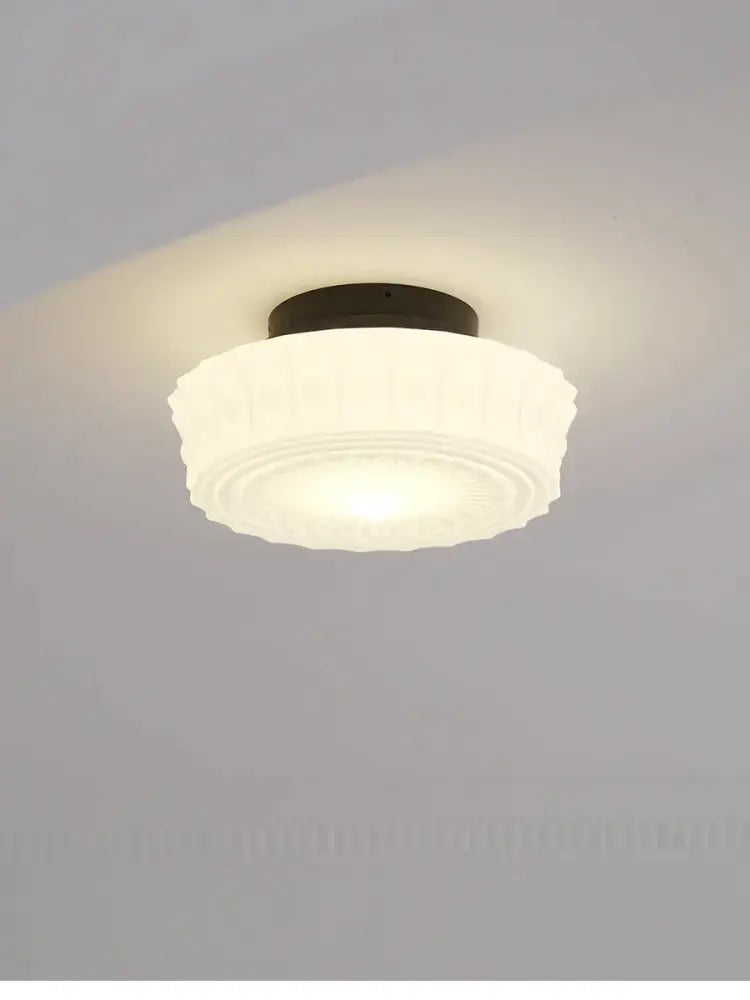 Frosted white glass ceiling light with dark metal base and ridged design in decorbites french retro shanghai style