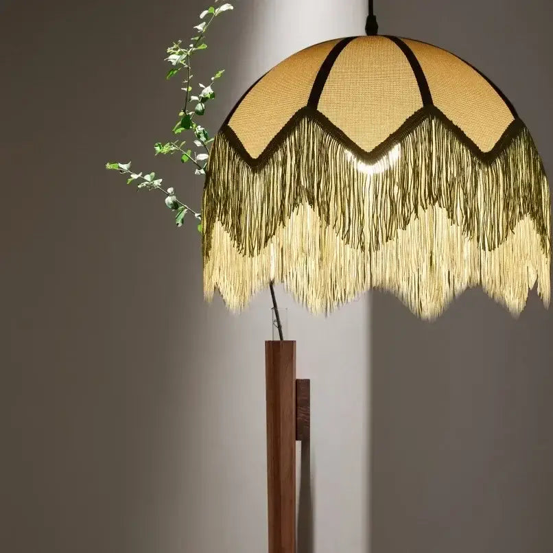 A warm-toned french retro style woven fabric fringed pendant lamp with dark trim for retro style bedroom decorbites