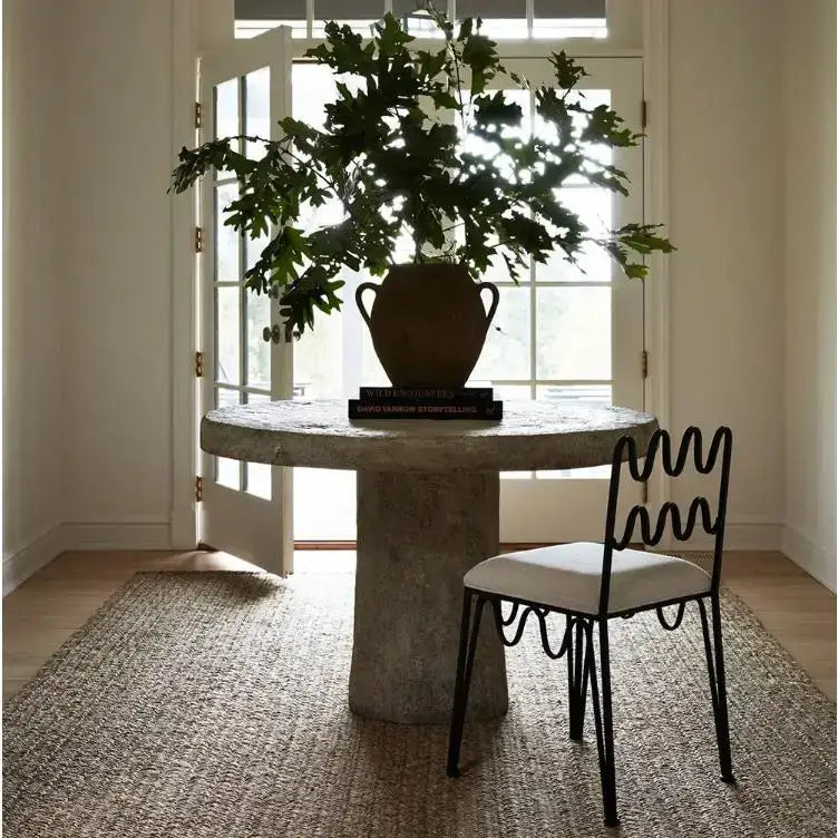 A rustic terracotta vase with two handles holding a green leafy plant complementing decorbites french retro wave dining table set