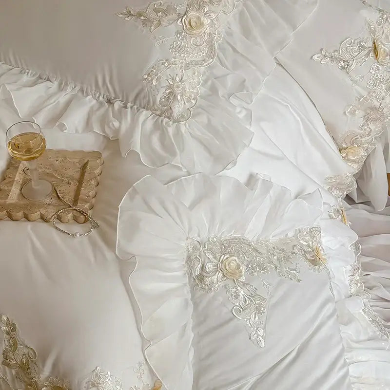Elegant white satin bedding set with intricate silver lace appliqués and ruffled edges from decorbites french rose flowers