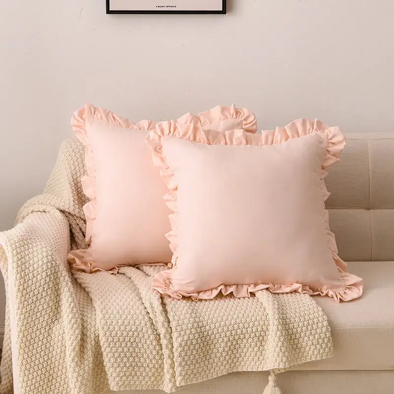 Two soft blush pink decorbites french ruffle pillowcases with delicate edges in smooth satin-like fabric for bedroom decor