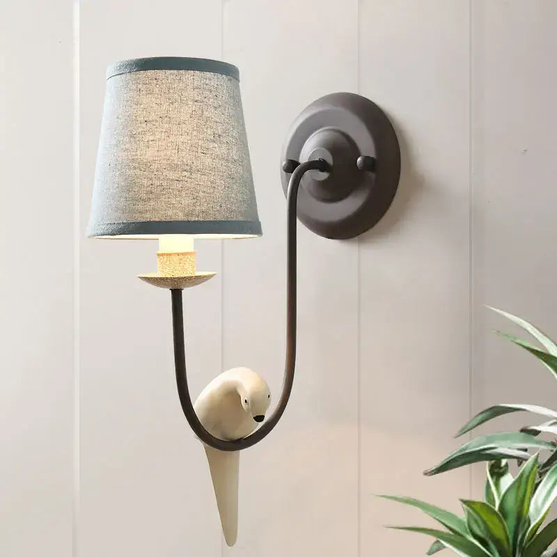French rural cream ceramic bird decor antique wall lamp with matte black frame, gray linen shade, and white bird decorbites bird decor