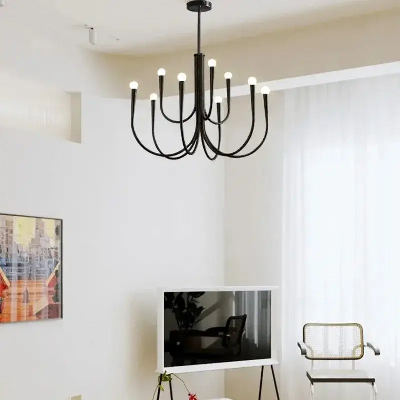 Black metal chandelier with multiple curved arms and glowing bulbs french style black pendant light decorbites french style