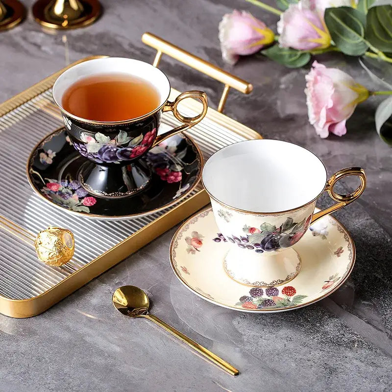 Elegant black and cream decorbites bone china teaware set with gold rims floral fruit patterns and matching tea cups and saucers