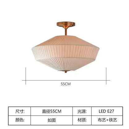 A modern french style fabric pleated ceiling lamp in soft beige with brass light accents for bedroom decorbites